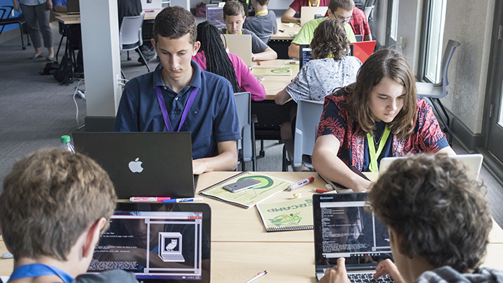 CyberCamp students complete a challenge on their computers