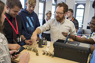 Nathan Fisk introduces students to a lock picking activity at CyberCamp 2018