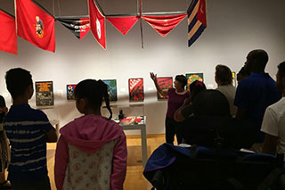 Students are guided through an art exhibit at the USF Contemporary Art Museum