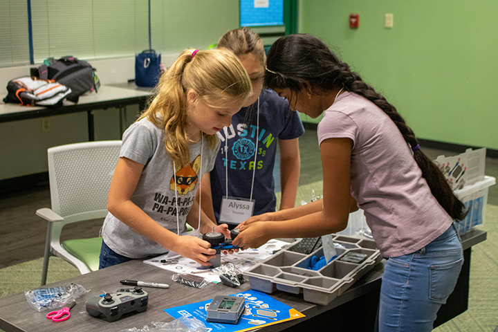 Girls working with VEX IQ robot at USF Robotics Summer Camp