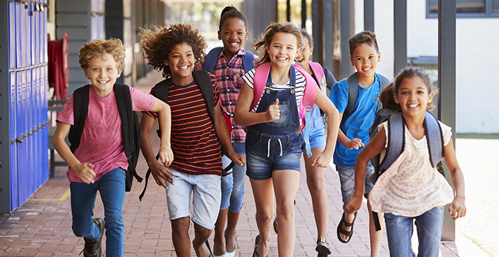 Students running down a hallway at school