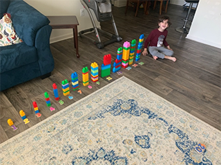 A young child practicing counting skills with blocks