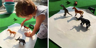 A child creates drawings from shadows of their toys