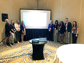 Randi Latzke and Jennifer Jacobs with students at a research conference