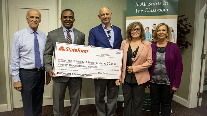 Group Photo of State Farm Check Presentation at Gus A. Stavros Center