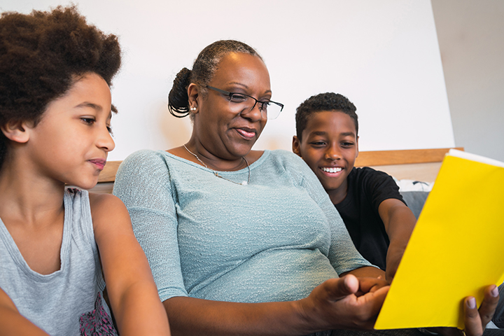 Grandmother reading with grandchildren