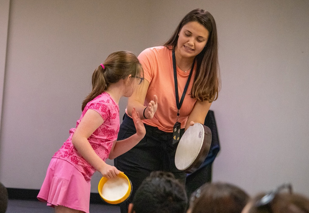 USF student Michaela Elza with a student at Pepin Academies