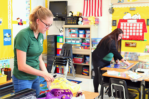 USF student and collaborating teacher setting up a classroom together