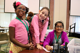 Team of girls work on building their VEX IQ robot