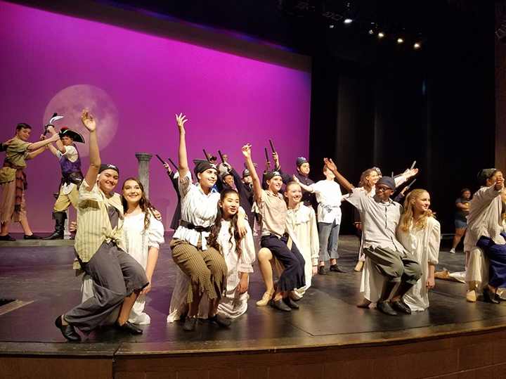 Student performers on stage at Booker Middle School