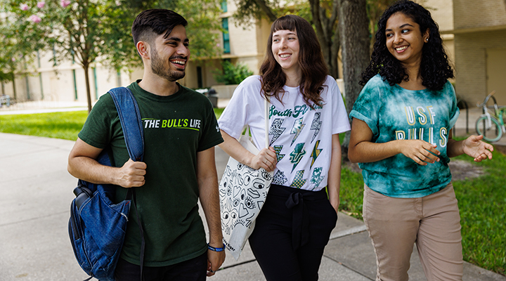students walking outdoors on campus