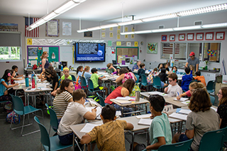 students in a classroom writing