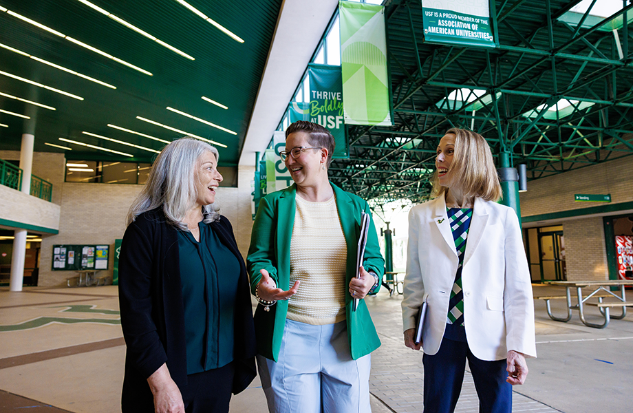 three people walking at USF stadium