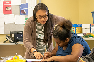 USF teaching intern working with a student