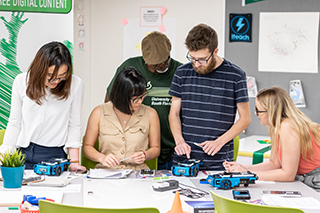 Mathematics Education majors study a robot in a lab