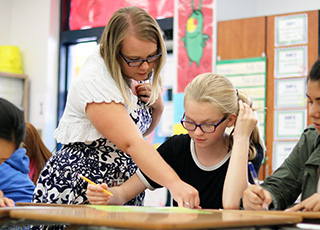 USF student teaching math in a middle school classroom