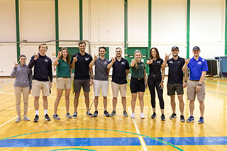 USF students pose for a photo in a gym on USF's Tampa campus