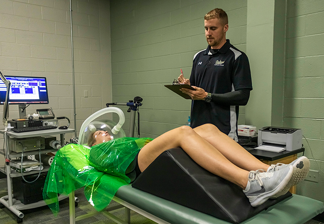 staff member testing person lying back wearing equipment
