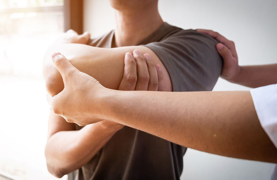 close up of a doctor stretching the arm of a patient