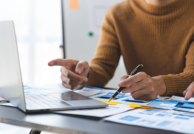 close up of hands working on laptop
