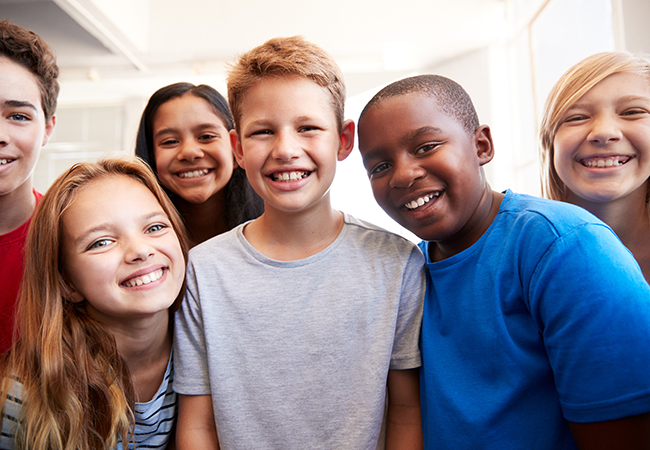 a group of young multicultural students smiling at camera