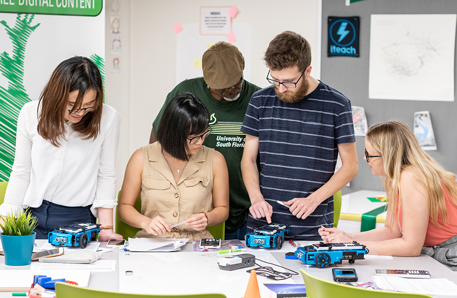 group of math education students working with TI calculator robots