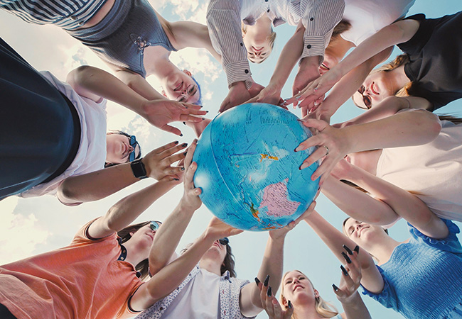 people holding a small globe