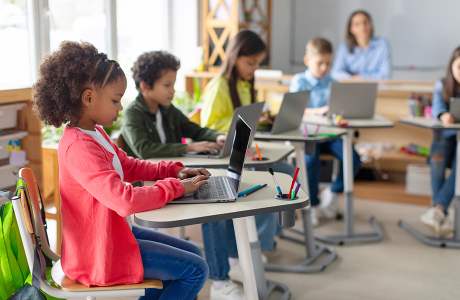 young children in a classroom on computers
