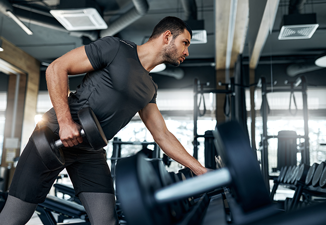a man in a gym lifting heavy weights