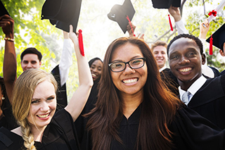 Graduates in regalia celebrating outside