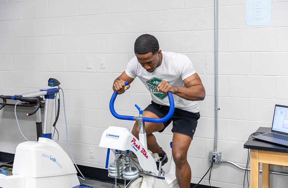 man rides stationary bike in lab