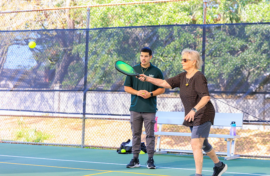 ESK student assists woman playing pickleball