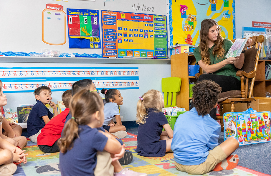 teacher demonstrates in front of classroom of small children