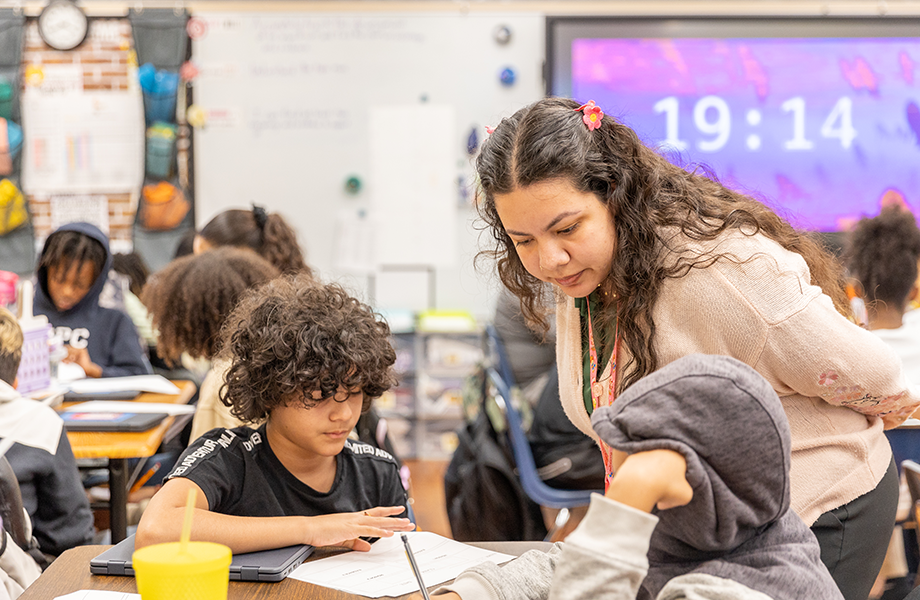 woman works with children in classroom