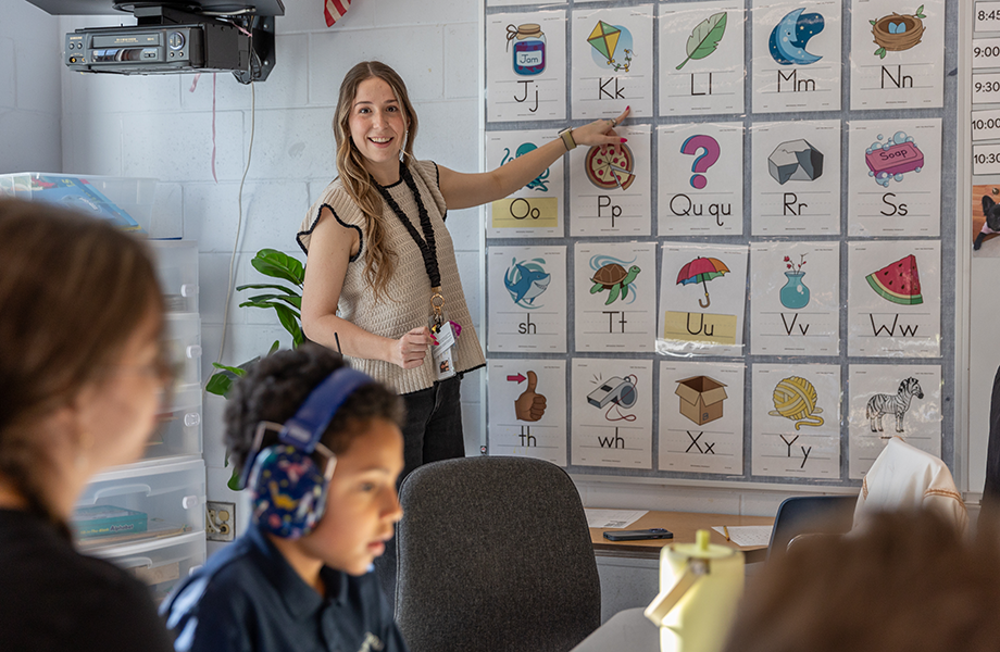 teacher demonstrates to classroom of young students