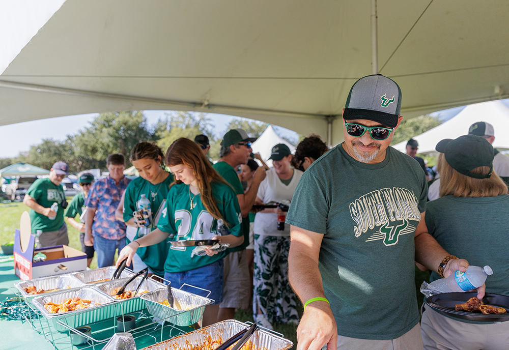 College of Education tailgate attendees in line for food