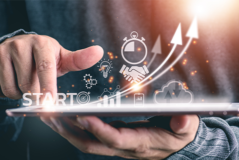 Hands holding graphic of startup figuratively growing 