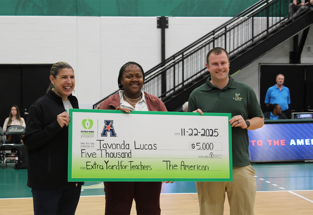 Lucas holding her surprise check