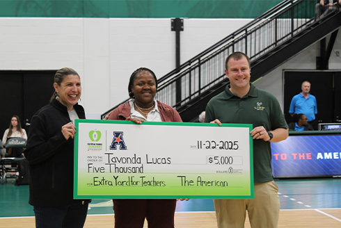 Lucas holding her surprise check