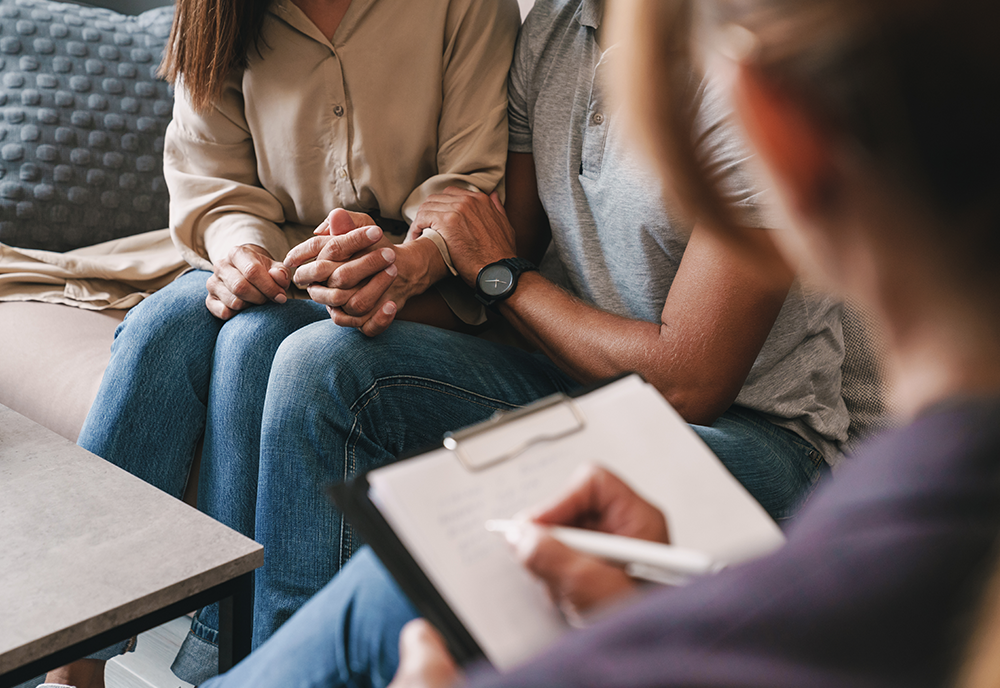 Couple in therapy holding hands