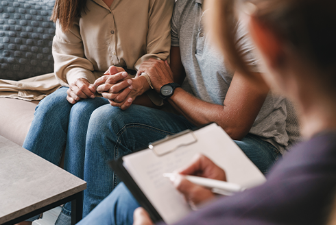 Counseling couple holding hands