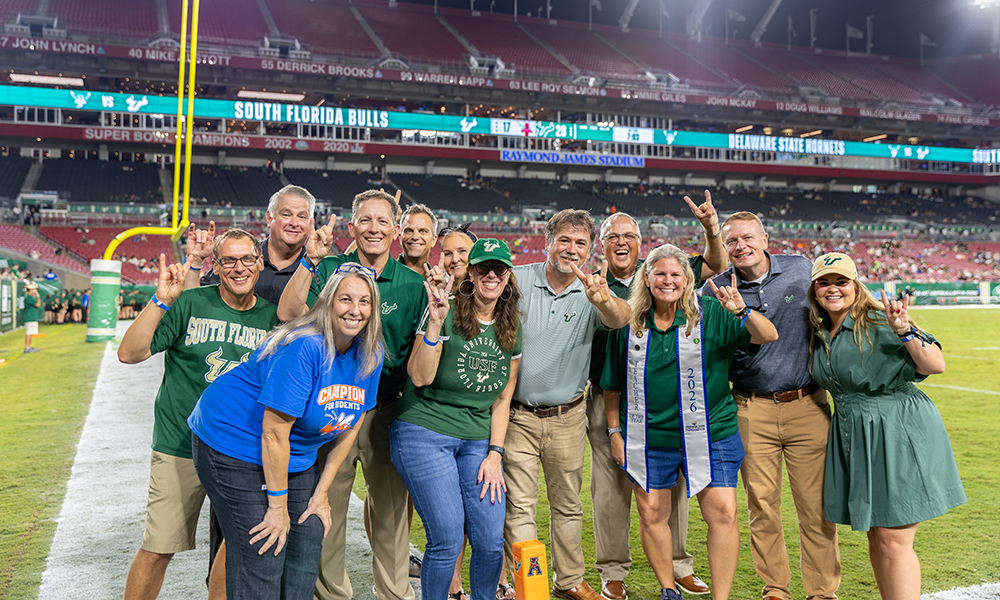 Group photo of teachers of the year being recognized on field during halftime