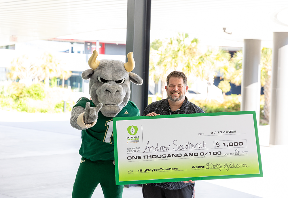 Andrew Southwick with Rocky and giant check