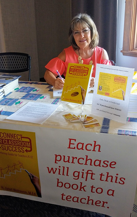 Janet Walraven seated at book event