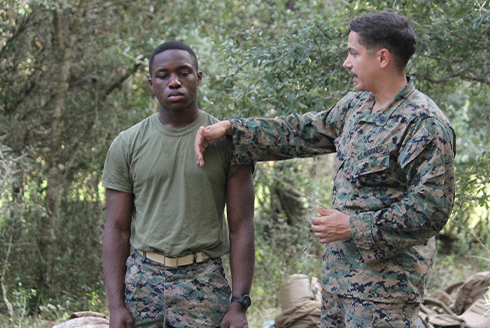 Issa in the field training a marine