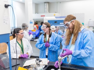 A picture of teachers in a chemistry lab smiling