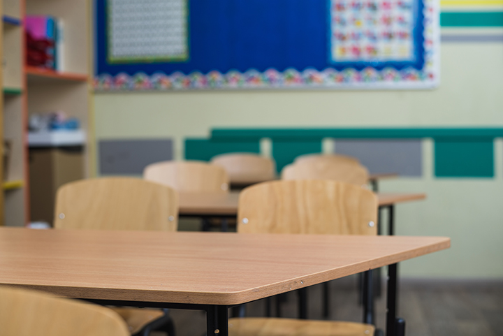 Empty classroom with wooden desks