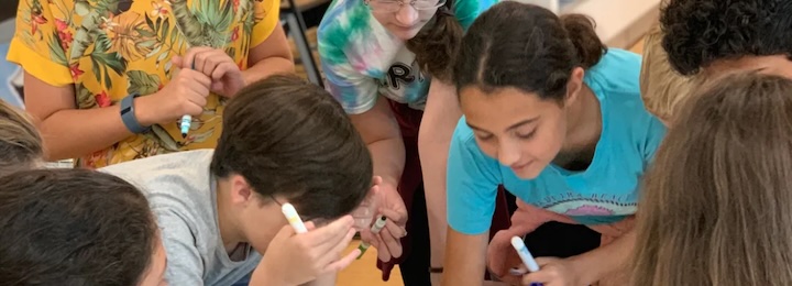 kids at a camp writing