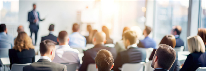 group of people listening to a lecture