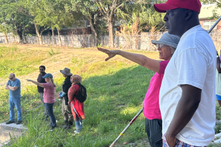 Community gathered by pond